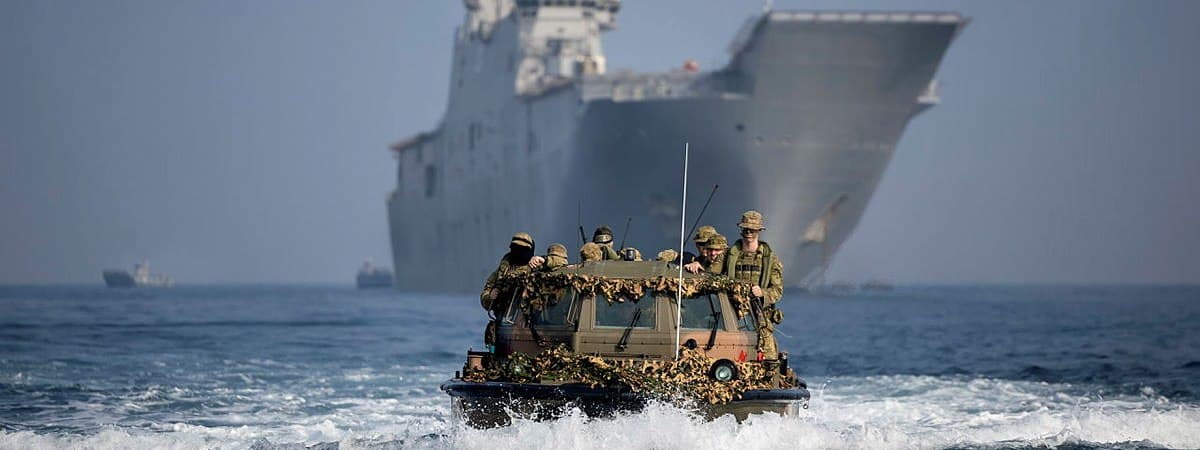 Military personnel on light amphibious craft. 