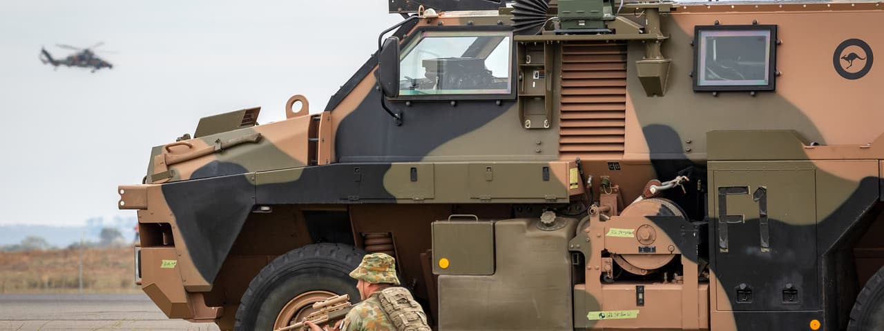 An Australian soldier beside a Bushmaster armoured personnel carrier from Thales Australia. 