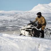 Military service member on snowmobile