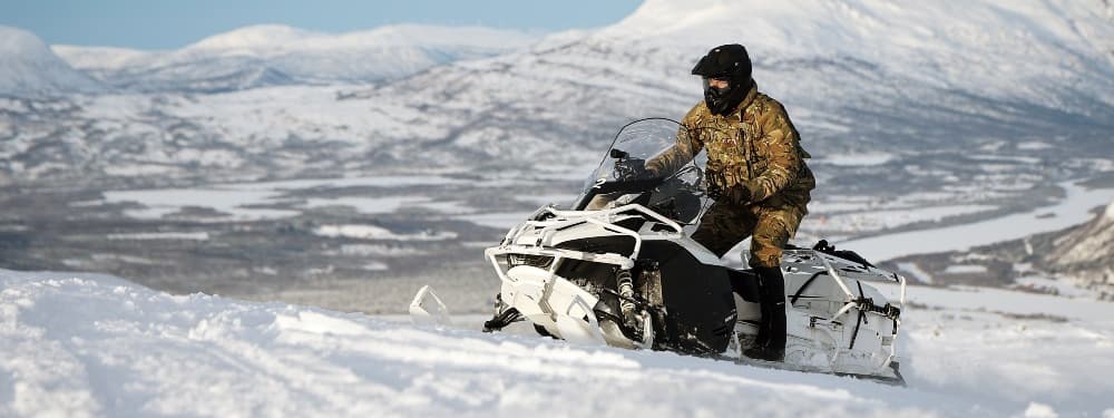 Military service member on snowmobile