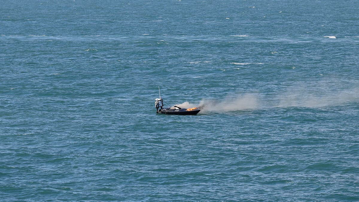 a USV on fire after being disabled during Royal Navy exercise Sharpshooter, which involved disabling uncrewed systems swarming on HMS Dauntless