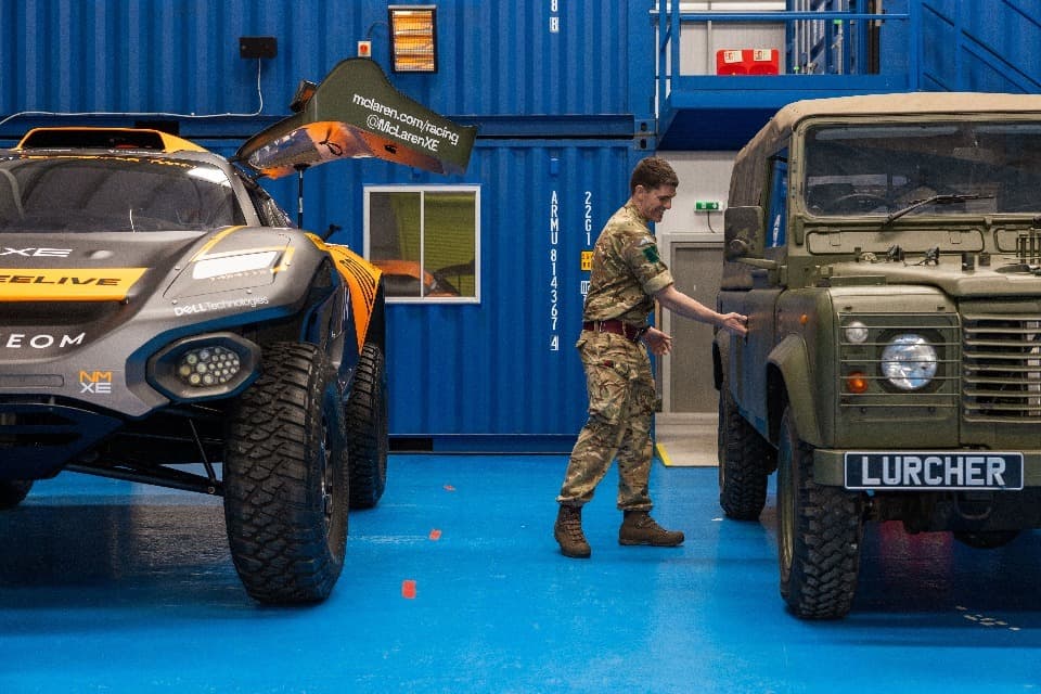 The ‘Neom’ McLaren Extreme E race car and a British Army land rover with an electric engine.