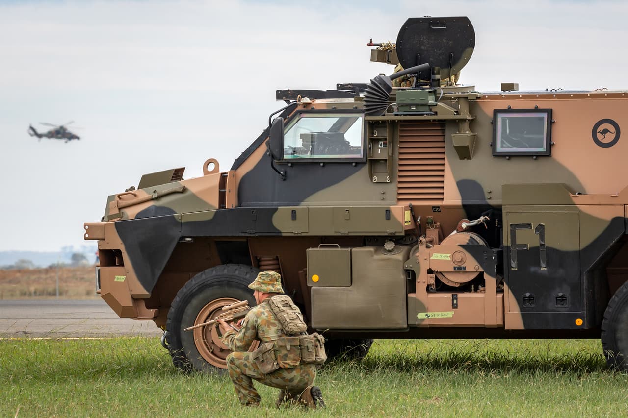 An Australian soldier beside a Bushmaster armoured personnel carrier from Thales Australia. 