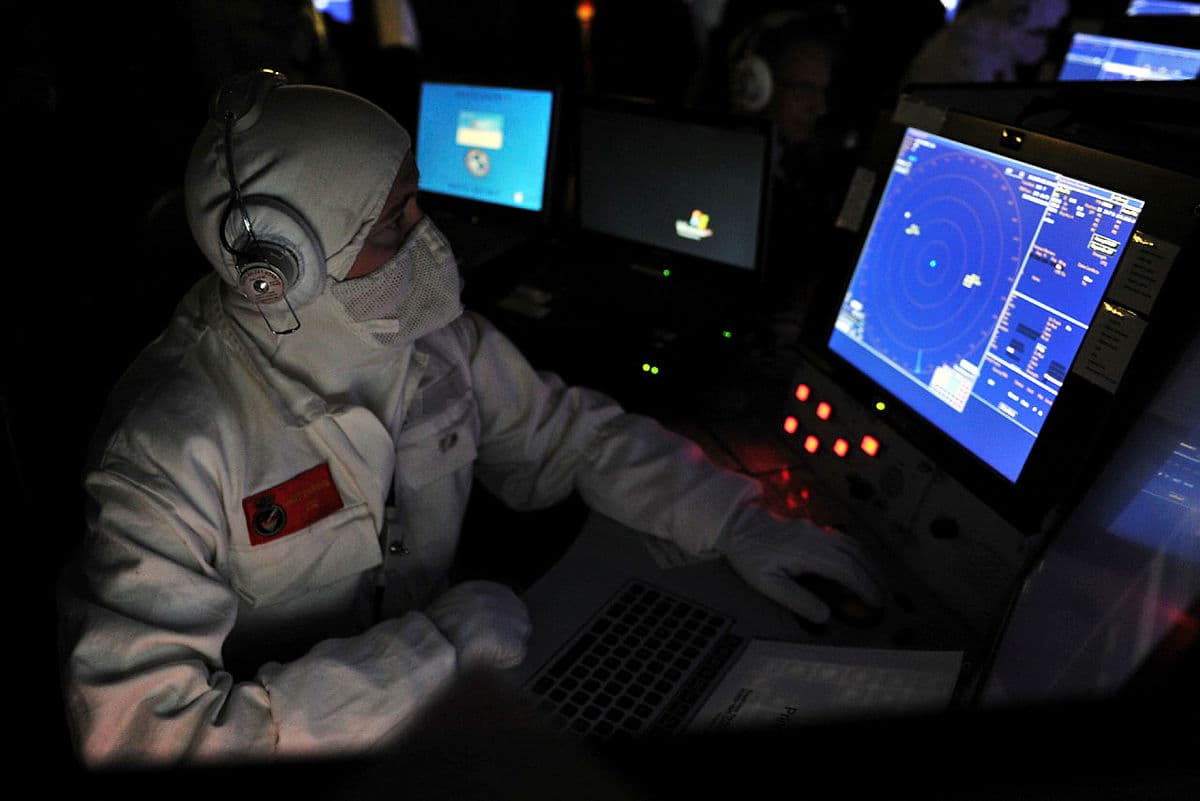 A sailor looking at a radar screen onboard the Royal Navy Type 45 destroyer HMS Daring.