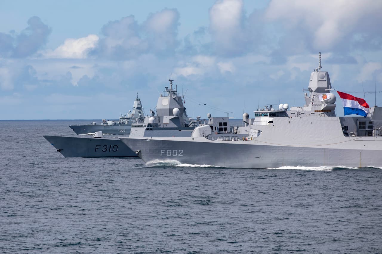 The German Navy frigate FGS Hamburg (rear) and the Royal Netherlands Navy frigate HNLMS De Zeven Provincien (foreground) participate in a NATO air-defence exercise in 2021. 