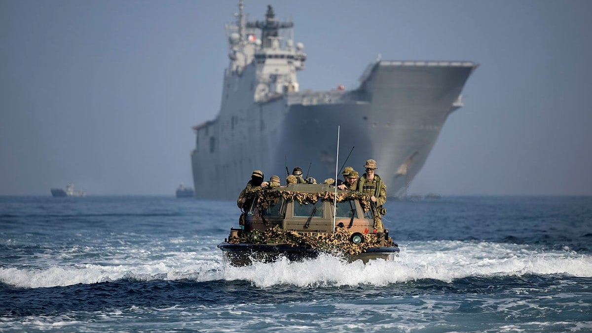 Military personnel on light amphibious craft. 