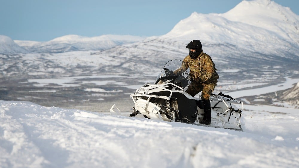 Military service member on snowmobile