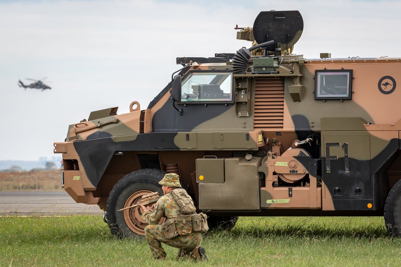 An Australian soldier beside a Bushmaster armoured personnel carrier from Thales Australia. 