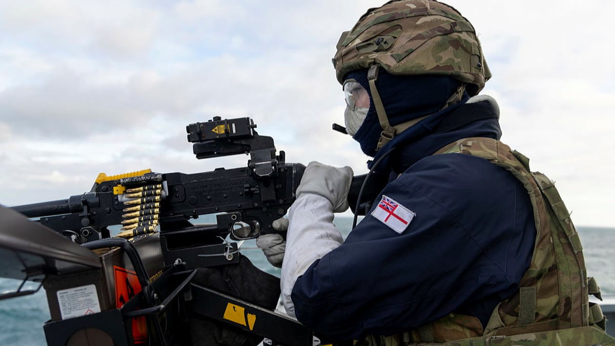 A Royal Navy sailor shooting down a drone during Exercise Sharpshooter - a Royal Navy exercise tasked with fending off attacks from autonomous threats. 